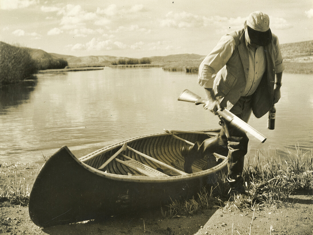 Ernest Hemingway stepping out of a canoe, Sun Valley, Idaho, October 1941. Photograph by Robert Capa, Ernest Hemingway Photograph Collection, John F. Kennedy Presidential Library