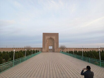 Man taking a photograph of Rabati Malik Caravanserai, Uzbekistan 