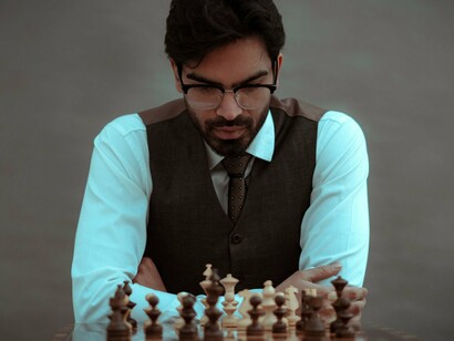A thoughtful player pausing to examine every possibility, reflecting the value of recalibrating before taking the next step
