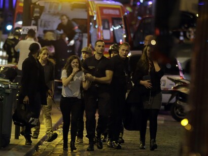 Rescuers evacuate people in the 10th arrondissement. Photograph: Kenzo Tribouillard/AFP/Getty Images