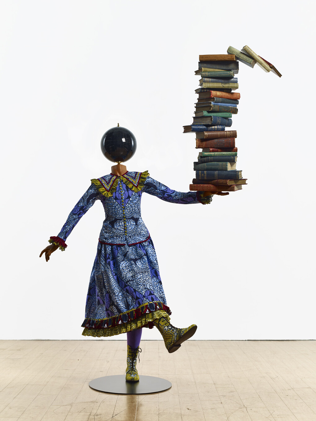 Yinka Shonibare MBE b. 1962, Girl Balancing Knowledge (2015)
Fibreglass mannequin, Dutch wax printed cotton textile, books, globe and steel baseplate
179 x 139 x 89 cm (70 1/2 x 54 3/4 x 35 in.)
Photographer: Stephen White
Image courtesy the artist, Stephen Friedman Gallery,
London and Pearl Lam Galleries, Hong Kong, Shanghai
and Singapore