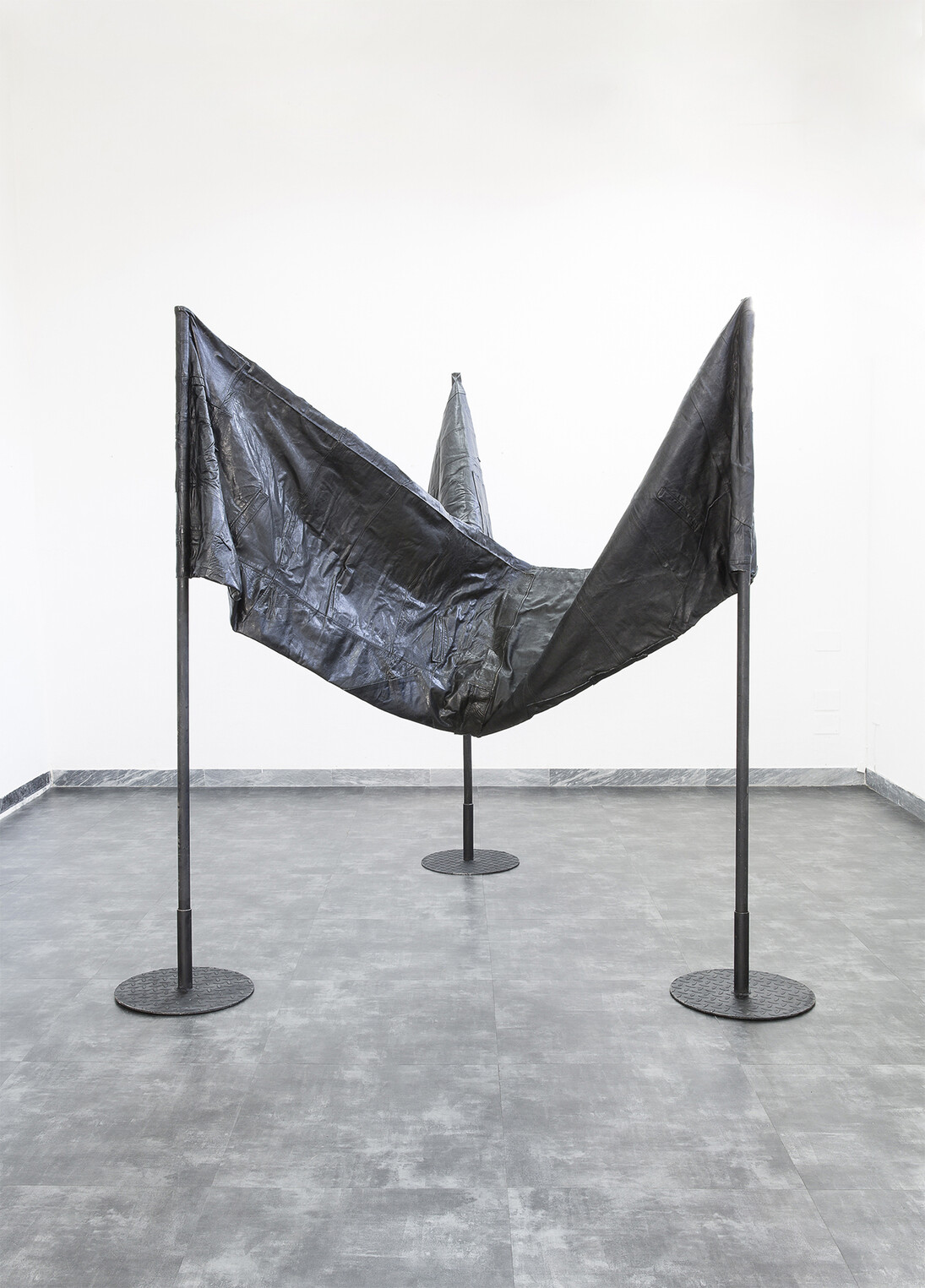 Apparatus 22
INFINITE CONTRADICTION
installation of three joint flags (reused black leather, wooden sticks, steel)
2016
Edition: 3 + 3AP   
