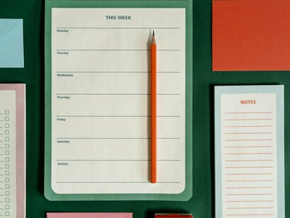 A blank weekly planner waiting to be filled, representing the act of breaking possibilities into manageable intentions