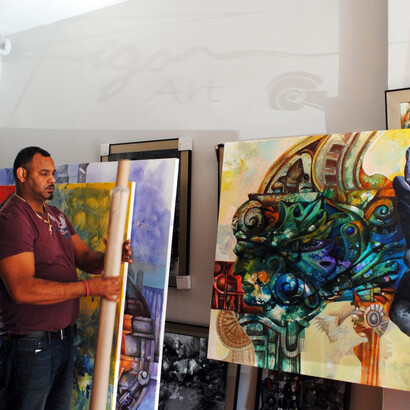 Rigo in his studio with one of the mural panels in progress at right