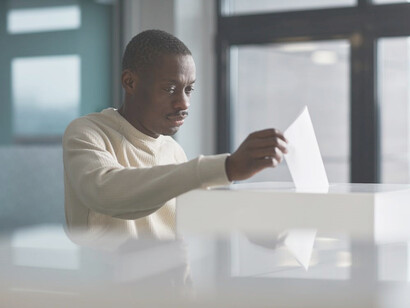 An African American man casting his vote in the election