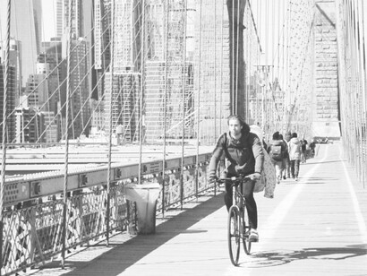 A cyclist crossing the Brooklyn Bridge in New York City, USA