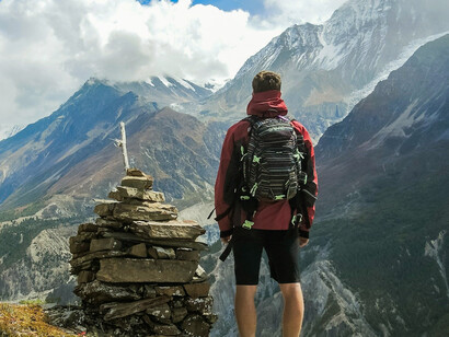 A man standing on top of mountain beside cairn stones, Ice Lake, Bhakra, Nepal