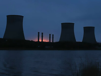 Nuclear power plant at night, showcasing fuel and power generation through nuclear reactor energy