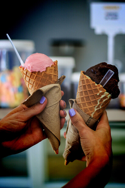 A detailed close-up of someone holding ice cream cones