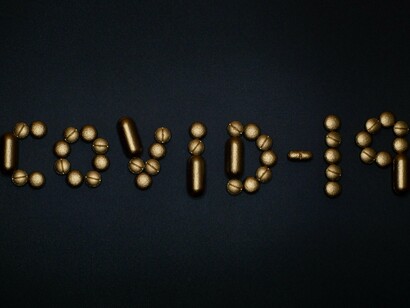 Pills shaping the term COVID-19, illustrating how the pandemic brought scientific communication into focus