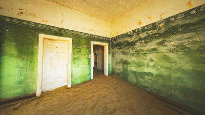 Doorways through time in an abandoned house in Kolmanskop, Namibia, photographed by Francesco Ungaro