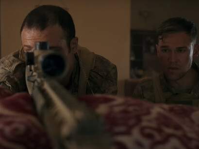 A sniper steadies his aim while his teammate watches—every breath, every blink calibrated for the unknown