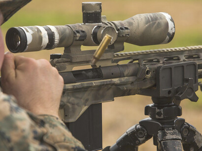 The skilled marine sniper took position, peering through the scope of his rifle, ready to execute precision shots when needed