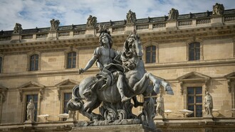 A monumental statue of Louis XIV towering before royal architecture, representing how the execution of a king rarely destroys the structures that sustained his power