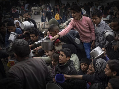 Niños palestinos con ollas en mano, piden comida a las autoridades encargadas en la Franja de Gaza