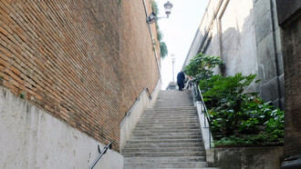 A man walking up countless steps 