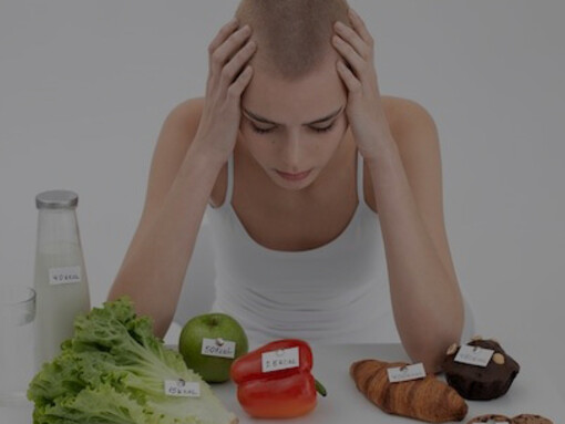 A young woman stands next to food items labeled with calorie counts, highlighting fake health claims and detox diets, illustrating the impact of cognitive biases in health