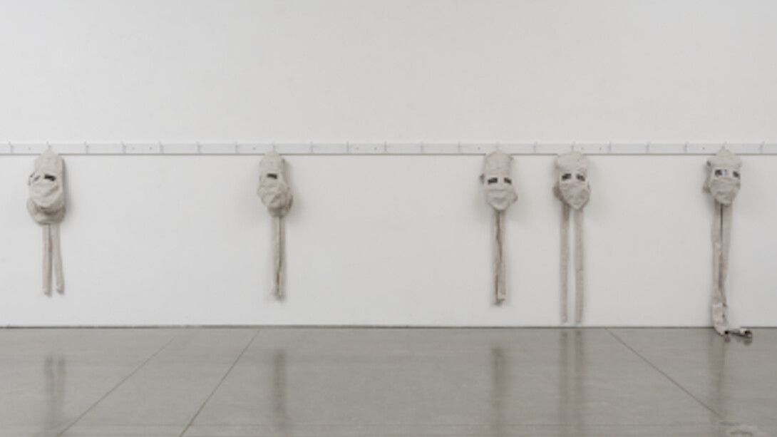 James Crosby, the Garrett Morgan safety hood allowing the wearer to breathe in a hostile environment, 2015, fabricated coat/hat rack, heavy canvas, polycarbonate welding lenses, 58 × 288 × 6in. (147.3 × 731.5 × 15.2cm). Courtesy of the artist and team (gallery, inc.), New York.