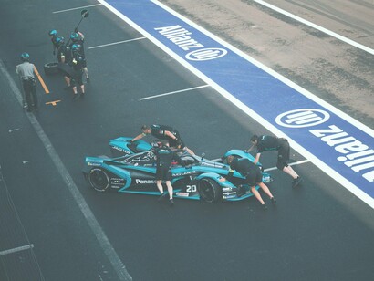 Men servicing car for racing tournament