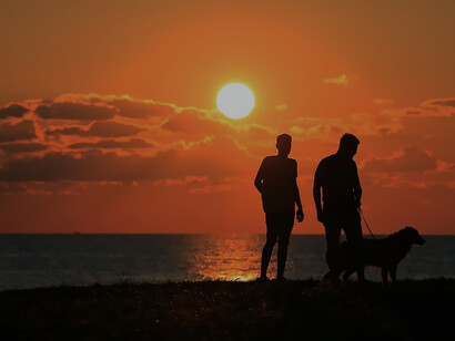 People walking at sunset