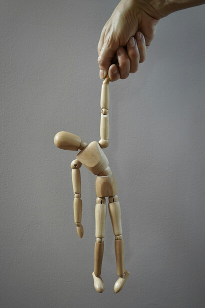 A wooden puppet controlled by power