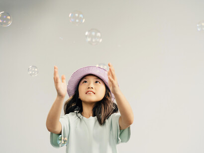 The girl is trying to catch the bubbles. Last year, scientists at MIT proposed deploying a raft of bubbles in space to reflect the sun
