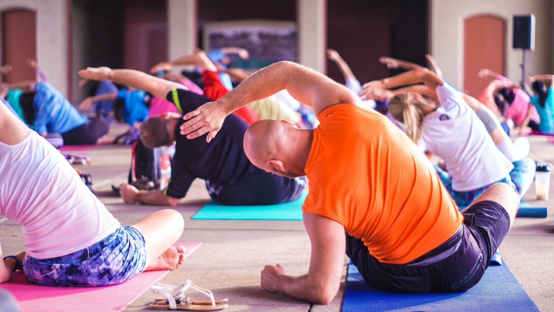 A group of business people practicing yoga as a route to being financially successful