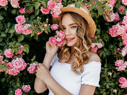 Bathed in blush and serenity, she holds a rose close—echoing the journey of self-trust and tender love