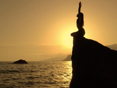 Meditating by the ocean, she demonstrates the beauty of embracing stillness, allowing the waves to wash away the noise of the world