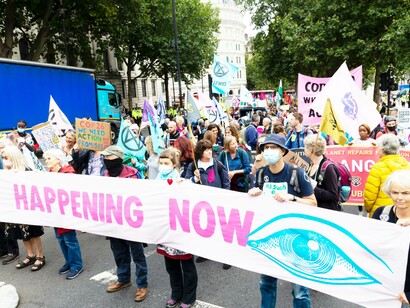 The public voicing their opinion with a large banners, signs, and flags
