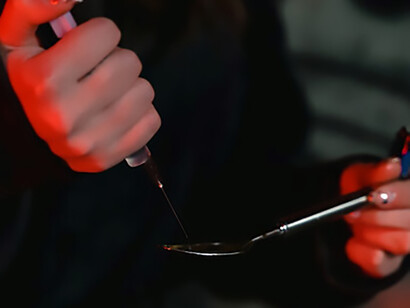A young woman gearing up for drug use, standing at the precipice of a critical decision