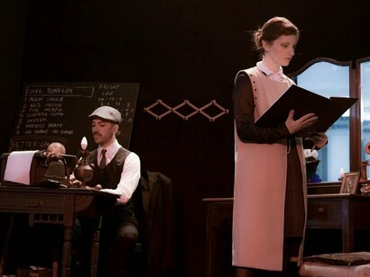 A woman reading a book beside a man at a typewriter, representing literature’s attempt to process illness and trauma
