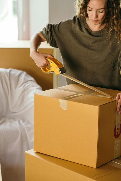 A woman packing up her bedroom, getting ready to move and start a new chapter in life