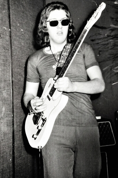 Marcello Capra on stage during a live performance, immersed in his music