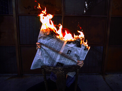 A newspaper on fire