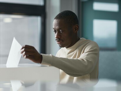 Man placing his vote into the ballot