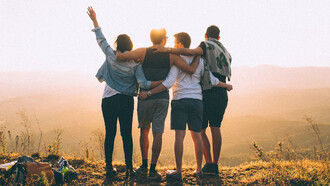 A tender embrace of friends under the sunset, reminding us that our strength often lies not in independence, but in the arms of those who never let us fall