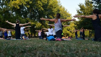 A group of people practicing yoga outdoors