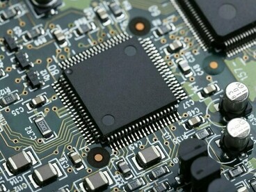 A high-tech circuit board featuring advanced semiconductor components, representing the transition from trade wars to technology wars