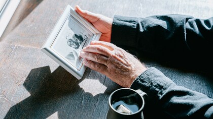 Person holding a photograph 