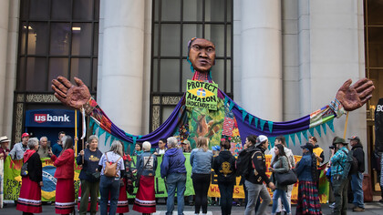A giant puppet, street mural, and road blockade outside the Brazilian Consulate in San Francisco, California, call on President Jair Bolsonaro to protect the Amazon and respect Indigenous rights
