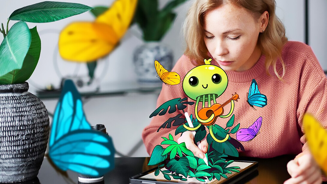 An image of a woman with a tablet device, showcasing her vibrant creativity, brings the concept of coming alive through technology to life