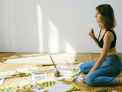 A woman taking the time to think about her upcoming handmade craftwork