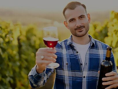 Experience the authentic charm of Hungary's vineyards as a young vintner delights in the rich bouquet of organic bio red wine, set against the backdrop of picturesque vineyard landscapes