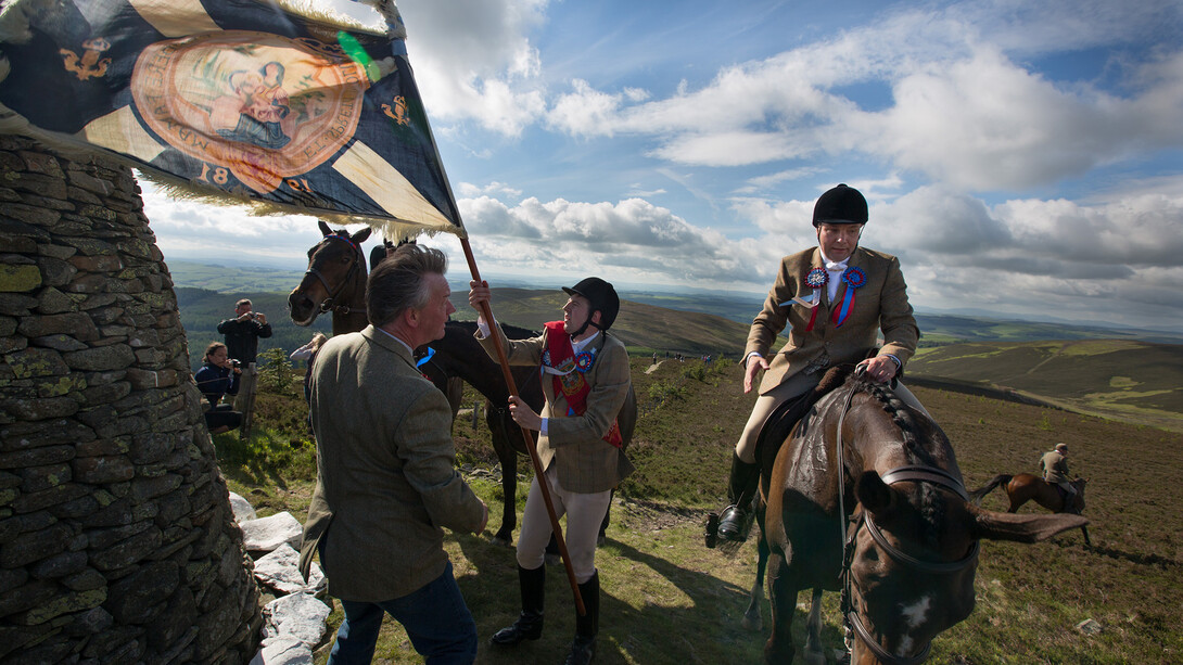 Jeremy Sutton-Hibbert, Royal Burgh Standard Bearer Martin Rodgerson and his Burleymen attendants, Three Brethren cairns summit, during the Common Riding festivities in Selkirk, Scotland, 2013 from the series Unsullied and Untarnished © Jeremy Sutton-Hibbert/Document Scotland 
