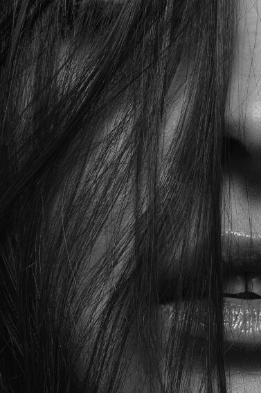 A portrait of a beautiful woman with black hair, capturing her feminine and sexy elegance