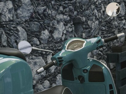 This isn’t just a scooter—it’s Italy in miniature: bold color, elegant design, and a longing for somewhere just beyond the curve