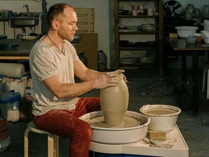 A ceramic pot maker concentrating on his latest moulding creation