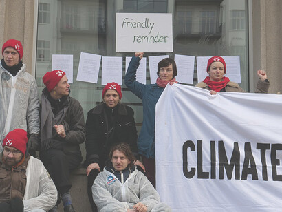 Protest against BUND's endorsement of Coal Commission outcomes features hanging of Paris Climate Agreement on office windows and doors