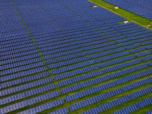 Solar panels in a field. To increase durability, transparency, UV-resistance, heat-resistance, mechanical strength, dirt-repellency and energy production, a solar panel’s frame, front sheet, back sheet and encapsulant each, typically, hold perfluorinated chemicals (PFAs)